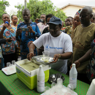 WFP staff serving nutrient-rich meal to alleviate malnutrition in Benin